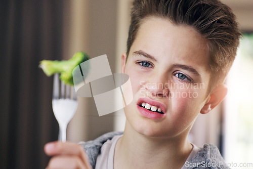 Image of Disgust, food and fear with child and broccoli for nutrition, health and cooking. Sad, angry and dinner with boy and refuse to eat vegetable at home for eating problem, frustrated and dislike