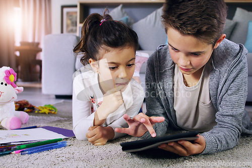 Image of Tablet, online and relax with children on floor of living room for streaming, social media and subscription. Internet, technology and app with kid siblings in family home for learning, movies and app