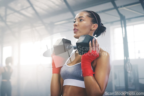 Image of Focus, sweating and dumbbell with woman in gym for training, weightlifting and workout. Health, strong and sports with female bodybuilder in fitness center for exercise, motivation and wellness