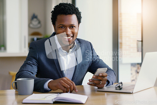 Image of Freelancer, black man and portrait with phone and smile from online investment job. Work from home, happiness and investor employee in house with mobile communication and internet research at desk