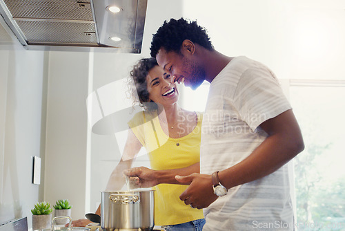 Image of Cooking, love and happy with couple in kitchen for bonding, breakfast and morning. Happiness, smile and food with man and woman preparing meal together at home for relax, nutrition and wellness