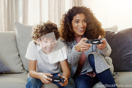 Image of Mother, son and controller with happiness for gaming on sofa with competition, contest or playing together in house. Mom, boy and online games on living room couch with excited face in family home