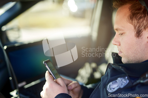 Image of Police, officer and man texting with phone in patrol car for security contact, law enforcement update and mobile notification. Policeman typing message on cellphone for crime news, connection and app