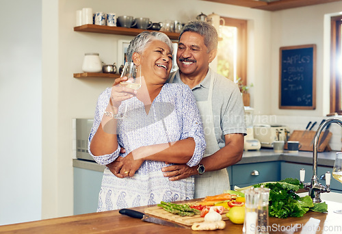 Image of Love, hug old couple in kitchen with wine, happiness and cooking healthy vegetable dinner together. Smile, embrace and food, senior man and happy woman in retirement with drink, vegetables and health