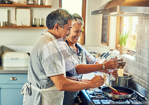 Image of Help, cooking together and old couple in kitchen with smile, health and frying healthy food at stove. Love, senior man helping happy woman prepare lunch and meal in pan, retirement and dinner in home