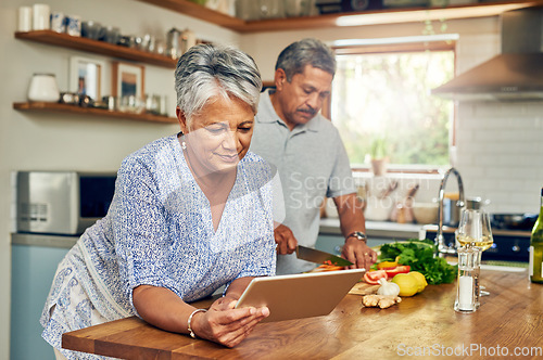 Image of Senior woman at kitchen counter with man, tablet and cooking healthy food together in home. Digital recipe, smile and old couple in house with meal prep, happiness and wellness diet in retirement.