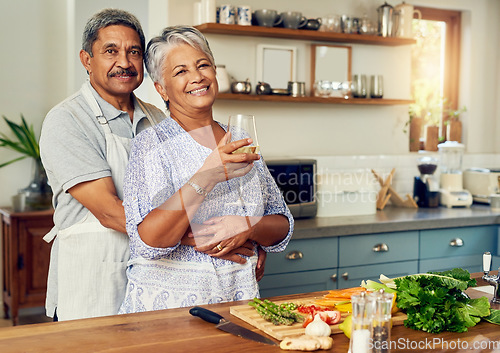 Image of Portrait of old couple in kitchen with wine, hug and cooking healthy vegetable dinner together. Smile, happiness and food, senior man and happy woman with alcohol, vegetables and retirement wellness.