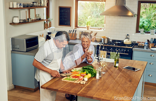 Image of Cooking, happiness and old couple with wine at kitchen counter, healthy food and marriage bonding in home. Drink, glass and vegetables, senior woman and man with vegetable meal prep and retirement.