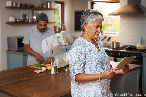 Image of Marriage, cooking and old couple in kitchen with tablet, healthy food and lunch time in home. Digital recipe, senior woman reading online and man making salad, nutrition and health in retirement diet