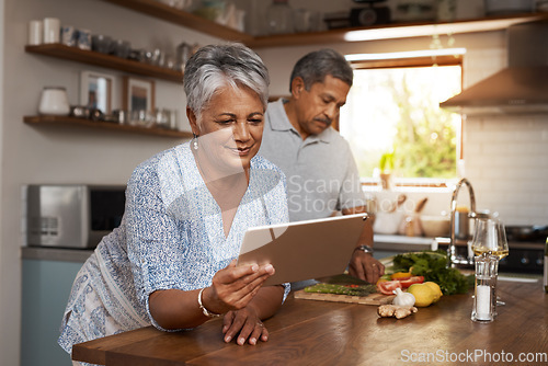 Image of Internet, old woman at kitchen counter with man and tablet, cooking healthy food together in home. Digital recipe, health and senior couple with meal prep, happiness and wellness diet in retirement.