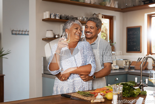 Image of Happiness, hug and old couple at kitchen counter with wine, food and cooking healthy dinner together. Smile, embrace and love, senior man and happy woman in retirement with drinks, vegetables and fun