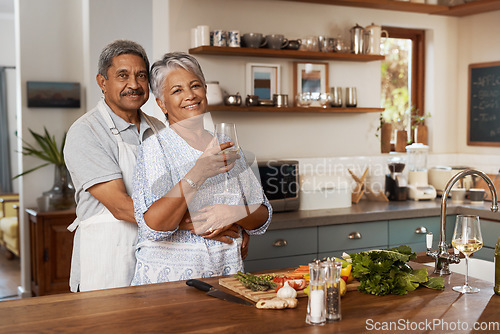 Image of Portrait of old couple at kitchen counter with wine, embrace and cooking healthy vegetable dinner together. Smile, happiness and food, senior man and happy woman with drink, vegetables and retirement