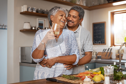 Image of Hug, old woman and man in kitchen with wine glass, happiness and cooking healthy vegetable dinner together. Smile, love and food, happy senior couple in retirement with drink, vegetables and wellness