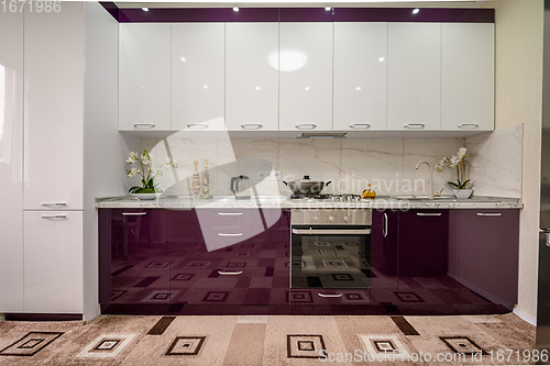 Image of Purple and white modern kitchen furniture, front view