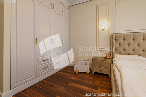 Image of Beige colored modern bedroom interior with double bed