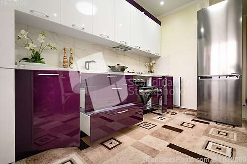 Image of Purple and white modern kitchen furniture, front view