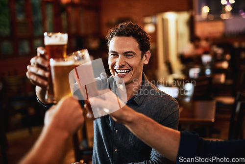 Image of Beers, cheers and man drinking with friends at social event in a restaurant with happiness. Alcohol, glasses and toast at a pub at happy hour with smile and conversation with drinks and celebration
