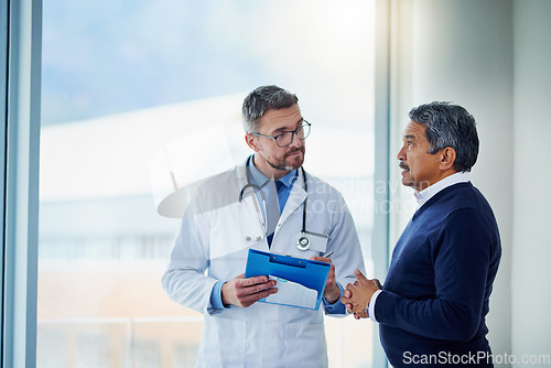 Image of Consultation, medical and doctor talking to patient and writing notes on a clipboard for diagnosis in a clinic. Medicine, healthcare and professional man consulting person with health insurance