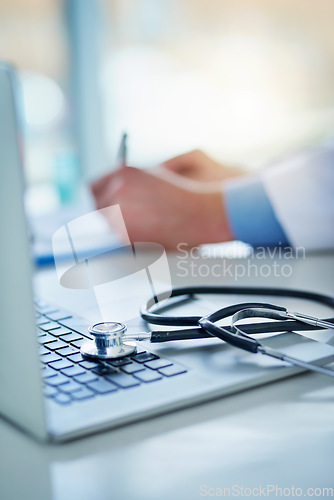 Image of Computer, stethoscope and doctor hands writing on clipboard, healthcare information and research for insurance. Paperwork, documents and checklist of medical professional at desk on laptop and notes