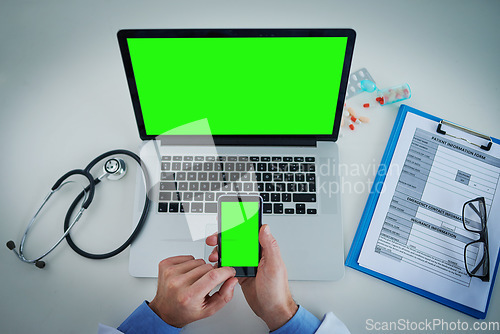 Image of Phone, green screen and doctor on laptop for healthcare service, online planning and research with hands above. Space, telehealth and pills of medical person typing on mobile app, mockup and computer