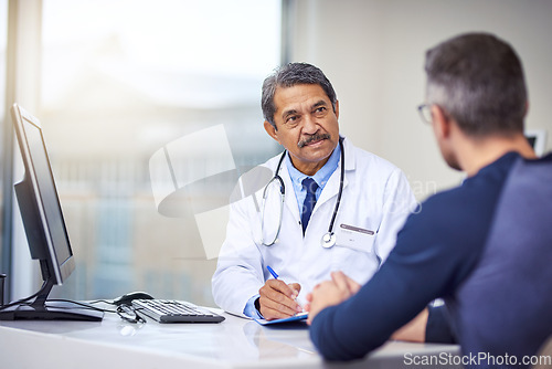 Image of Medical, discussion and doctor in a consultation with a patient analyzing diagnosis in the clinic. Professional, conversation and mature male healthcare worker talking to man in the medicare hospital