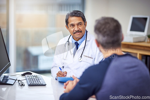 Image of Healthcare, consultation and male doctor talking to a patient about a diagnosis in the clinic. Professional, discussion and mature medical worker in discussion with a man in the medicare hospital.