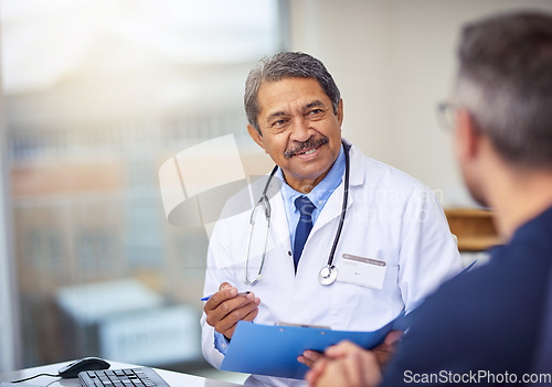 Image of Healthcare, discussion and doctor with a patient for a consultation in the office in clinic. Professional, conversation and mature male medical worker talking to man on diagnosis in medicare hospital