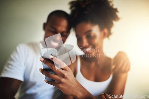 Image of Hand, cellphone and texting in home with happy couple for communication, social media app and meme together. Black man, woman and smartphone in house with reading, online chat and watch funny video