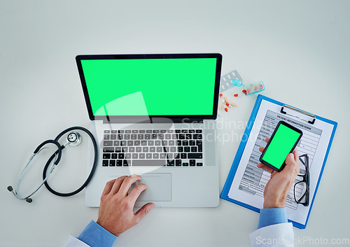 Image of Phone, green screen and doctor hands with documents, healthcare service and planning research on laptop above. Space, telehealth and pills of medical person typing on mobile app mock up and computer