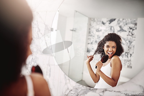 Image of Woman, beauty and singing in mirror at apartment for haircare, fun, and preparing for the day. Female glow, happy and skincare with singer in the mirror for morning routine with hair and happiness.