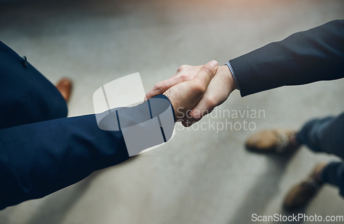 Image of Handshake, partnership and b2b with business men in the office for agreement, deal or company merger. Meeting, greeting or interview with people shaking hands at work to say thank you from above
