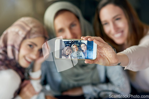 Image of Muslim women, friends and selfie with phone, smile and happiness for post on blog, app or social network. Happy islamic woman, group and smartphone for photography, profile picture and memory on web