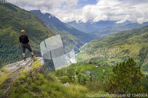 Image of Man standing on hill top in Himalayas