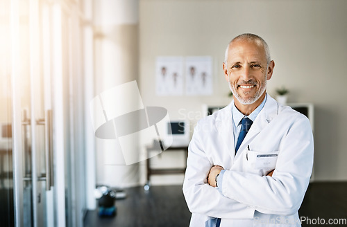 Image of Mature doctor, smile and portrait with arms crossed in hospital feeling proud from medical work. Healthcare, wellness and professional employee with happiness from health support and physician job