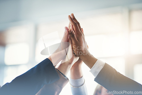 Image of High five, businesspeople and their hands together for cooperation with lens flare. Collaboration or teamwork, group or coworkers support and people with hand in air for unity or achievement