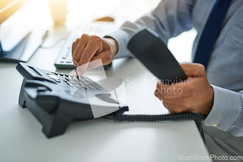 Image of Hand, telephone and business man dial a number at work or on desk or call centre for customer service and In the office. Employee, telemarketing and receptionist or consulting and communication