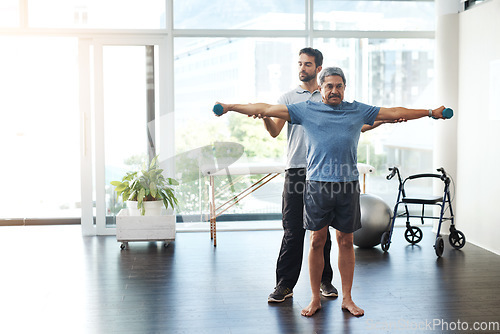 Image of Training, physiotherapy and stretching with doctor and patient for rehabilitation, dumbbells and help. Healthcare, wellness and healing with old man and expert for consulting, muscle and exercise