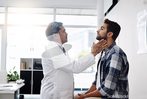 Image of Healthcare, consultation and doctor checking throat of patient with advice, help and solution. Medicine, health care and Indian man with neck pain in doctors office consulting medical professional.