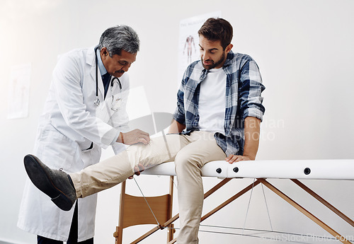 Image of Knee pain, patient and doctor in clinic, health care and help at wellness checkup of person at hospital. Medicine, healthcare and man with leg injury in doctors office consulting medical professional