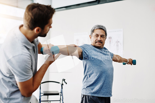 Image of Dumbbells, physiotherapy and stretching with doctor and old man for rehabilitation, training and help. Healthcare, wellness and healing with patient and expert for consulting, muscle and exercise