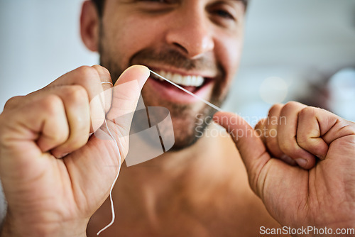 Image of Hands, face and man floss teeth for smile, dental health and care for gum gingivitis at home. Closeup of happy guy, oral thread and cleaning mouth for fresh breath, tooth hygiene and healthy habit