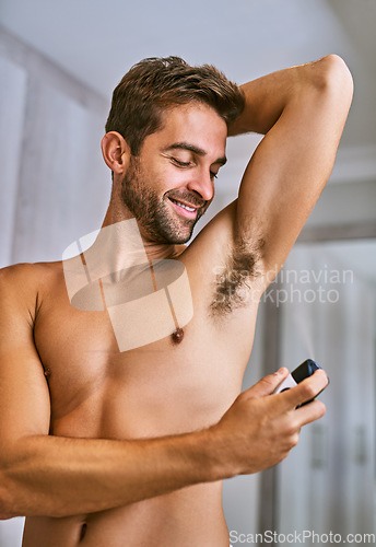 Image of Deodorant, man or spray armpit after shower in home for hygiene, male grooming or perfume to control sweating. Happy shirtless guy cleaning underarm with fragrance cosmetics, body product or skincare