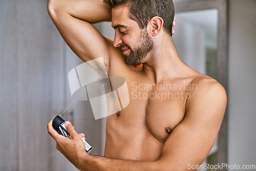 Image of Deodorant, spray and man in bathroom for body hygiene, shower and perfume mist to control sweating. Happy bare guy cleaning armpit with fragrance cosmetics, skincare product and male grooming at home