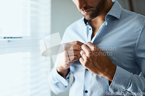 Image of Closeup, man and button shirt of clothes for job interview, work and corporate fashion for business. Hands of male person getting ready in professional outfit from wardrobe in the morning at home