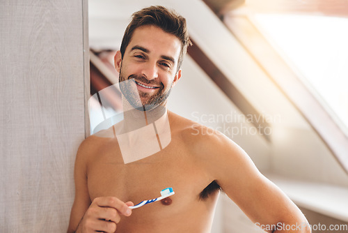 Image of Portrait, shirtless and happy man brushing teeth in bathroom for dental wellness, healthy smile and body with care at home. Sexy guy, toothbrush and oral cleaning for fresh breath and morning hygiene