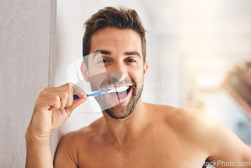 Image of Portrait, toothbrush and happy man brushing teeth in morning for dental wellness, healthy habit and gums. Face of guy cleaning mouth for fresh breath, oral hygiene and routine in bathroom at home
