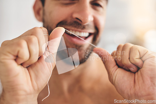 Image of Hands, face and man flossing teeth at home for dental health, plaque and gingivitis on gums. Closeup of guy, oral thread and cleaning mouth for fresh breath, tooth hygiene and habit to care for smile