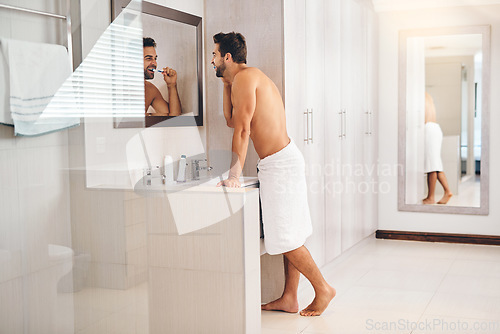 Image of Happy man, bathroom and brushing teeth at mirror for healthy smile, dental hygiene and gum care. Shirtless guy, shower and cleaning mouth with toothbrush for fresh breath, grooming or morning routine