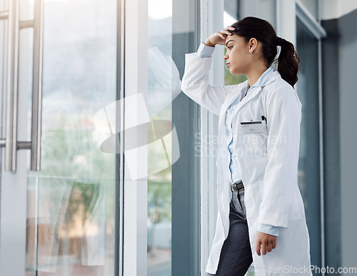 Image of Stress, doctor and woman in hospital thinking with worry, anxiety and tired with headache in clinic. Healthcare, mental health and sad female health worker with stressed out, depression and burnout