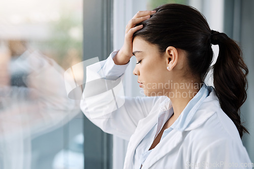 Image of Stress, sad doctor and woman by hospital window with worry, anxiety and tired with headache in clinic. Healthcare, mental health and stressed female worker with frustrated, depression and burnout